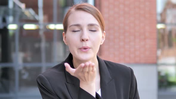 Flying Kiss by Young Businessman Standing Outdoor