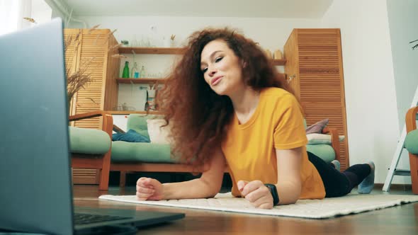 Woman Works with Laptop and Exercises During Self-isolation