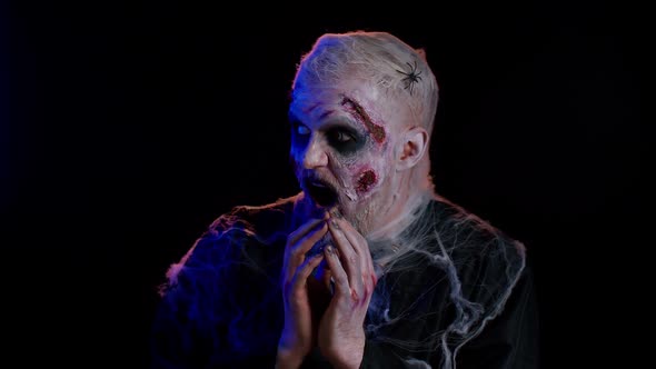 Frightening Man with Halloween Zombie Undead Bloody Wounded Face Makeup Scared By Police Ligths