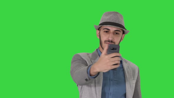 Arabian Man in the Casual Clothes Walking and Making Selfie on a Green Screen, Chroma Key