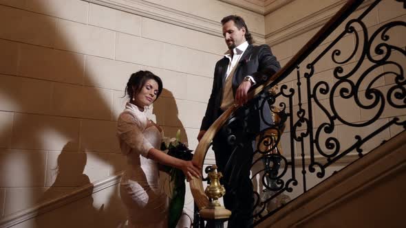 Romantic Loving Couple on Beautiful Staircase in Luxury Interior Hotel or Palace