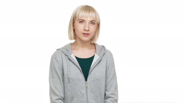 Closeup Portrait of Charming Blond Woman with Bob Haircut and Bangs Posing at Camera with Playful