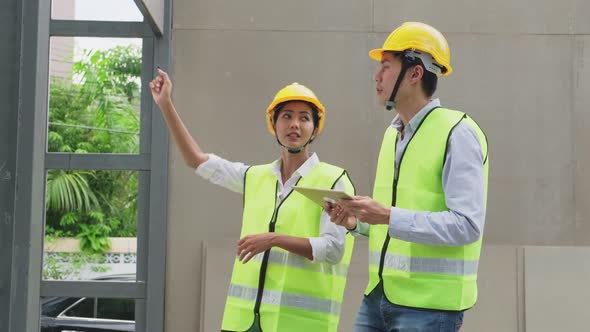 Asian colleague construction workers people wearing protective safety helmet and glasses on site.