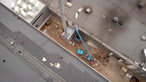 Workers at a Construction Site. The Process of Hydro Insulation of the Roof