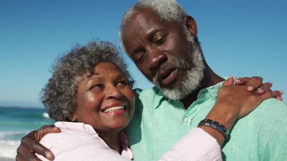 Senior couple looking at the camera at the beach