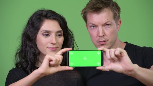 Young Couple Showing Phone Together