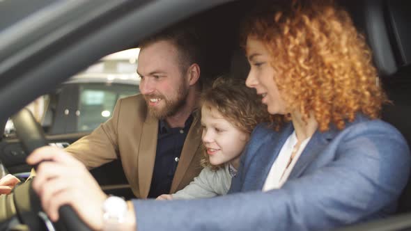 Happy Caucasian Family Now the Owners of New Car.