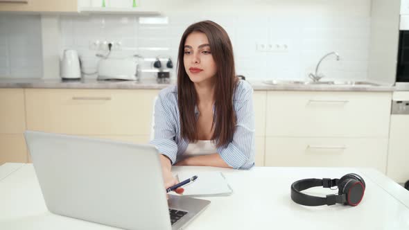 Smiling Young Woman Studying or Working Online at Home