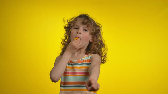 Cute Little Girl is Blowing in a Whistle and Making a No Gesture in a Camera