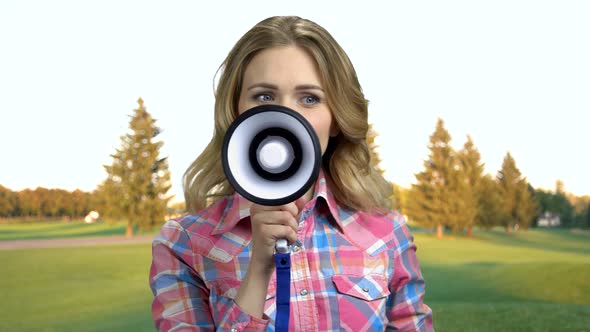 Close Up Young Delighted Woman Talking Into Megaphone.