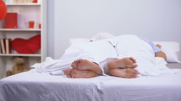Husband and Wife Sleeping in Bed, Healthy Feet Seen Under Blanket, Antifungals