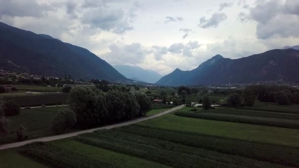 Aerial panoramic view of Levico Terme, Italy, during sunrise with views of the mountains.