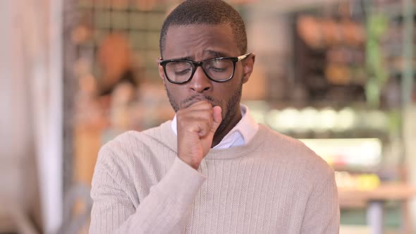 Portrait of Sick Young African Man Coughing