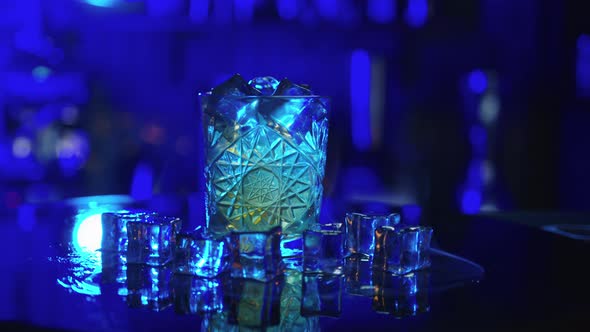 Bartender Sets Fire to Alcohol Cocktail Blue Background