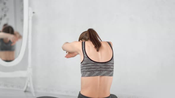 Sportswoman Enjoying Breathing Exercising Waving Hand in Front of Mirror at Yoga Studio Back View