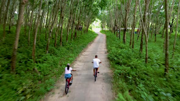 Couple Men and Woman on Bicycle in the Jungle of Koh Yao Yai Thailand Men and Woman Bicycling