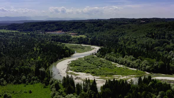 Curvy Isar river in southern bavaria besides a beautiful summer forest landscape, typical for the be