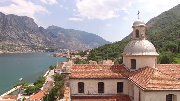 Drone View of the Tiled Roof and Barred Windows of the Church on the Banks of the Prcanj