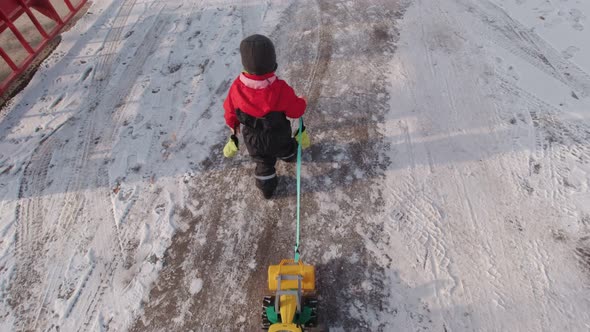 Boy Walking On A Winter Street Slow Motion