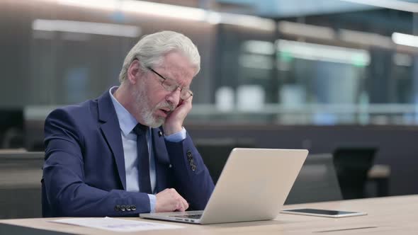 Old Businessman with Laptop Taking Nap at Work