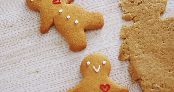 Gingerbread dough with cookie cutter on wooden table 4k