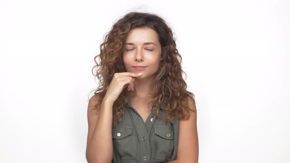 Charming Smiling Girl Flirting Winking on Camera Planning Something Tricky Isolated on White