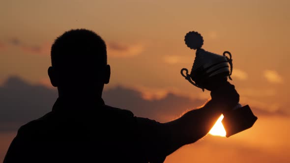 Silhouette Best Man Winner Award Victory Trophy for Professional Champion Challenge Holding Trophy