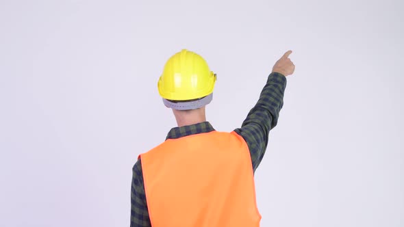 Rear View of Man Construction Worker Pointing Finger