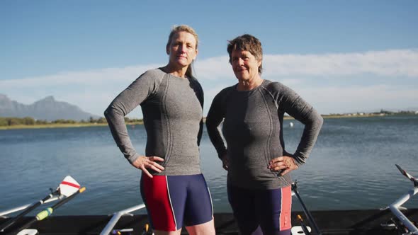 Portrait of two senior caucasian women standing by a river