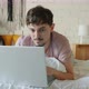 Husband Working with Laptop Typing While Wife Using Smartphone in Bed in Apartment - VideoHive Item for Sale