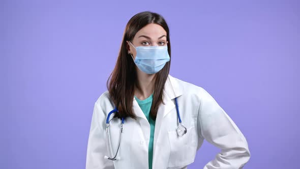 Portrait of Nurse in Protective Medical Mask and Coat Disapproving with No Head and Finger Gesture