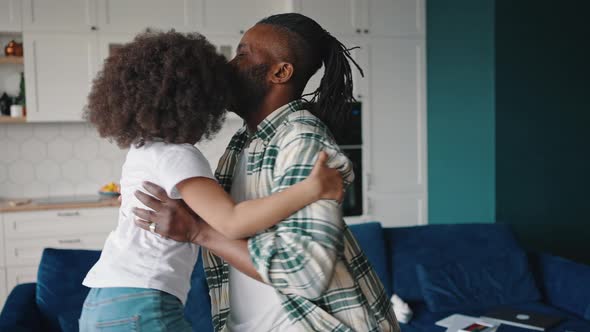 Happy African American Father Catching His Little Daughter Picking Her Up and Twisting Around Slow