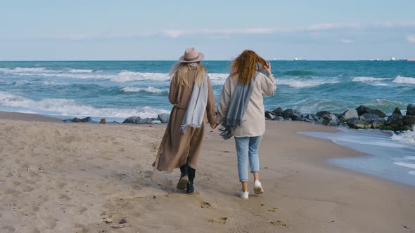 Beautiful Girls Walk Near the Sea