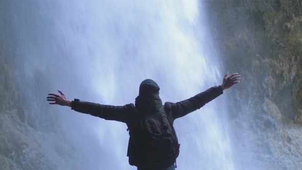 Man Traveler Under Famous Waterfall Kvernufoss in Iceland