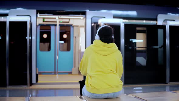 Young Woman Waiting for Subway Train to Arrive at the Station Gets on a Train