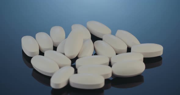 Prescription drugs - Capsules, pills, tablets on reflective background