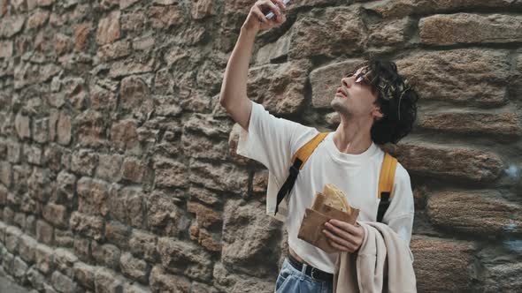 Young Hipster Man Taking Selfie with Taco Outdoors