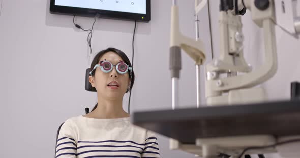 Asian Woman diagnosis eye test in clinic