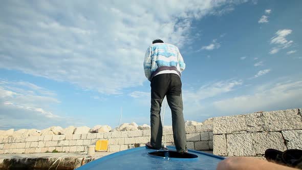 Man landing with small fishing boat on Premuda island in Croatia.