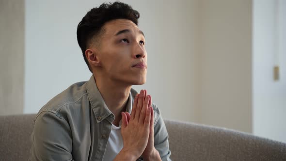 Young Asian Man Reads Prayer in Mind Putting Hands Together