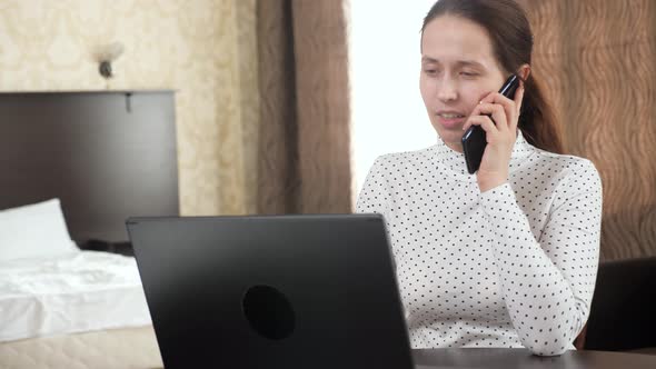 Professional Woman Works Using Computer Mobile Phone at Home