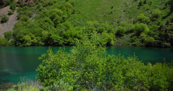 Small Mountain Lake of  blue color Urungach. Located in Uzbekistan, Central Asia. 6 out of 10