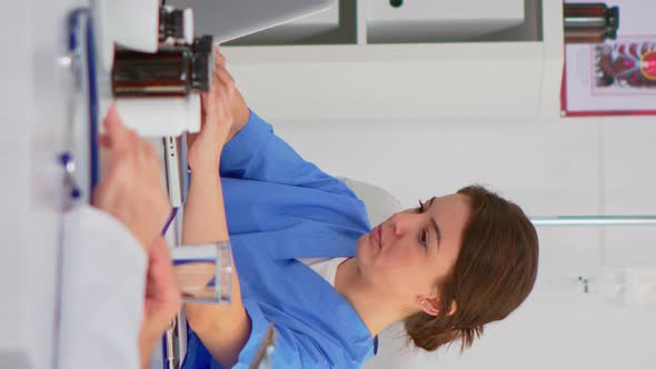 Vertical Video Woman Assistent Typing on Laptop at Desk Looking at Camera