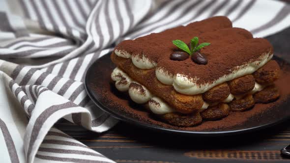 Classic Tiramisu Dessert on Ceramic Plate on Wooden Background