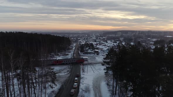 Aerial view of The electric train passes through the railway crossing at evening 08