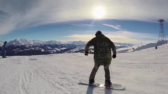 A young man snow boarding.