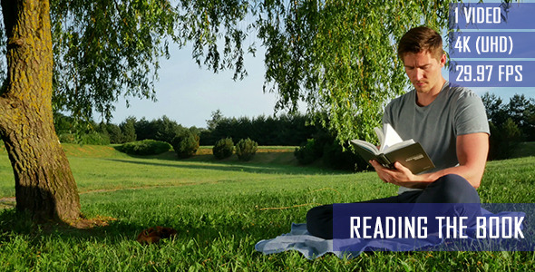 Healthy Guy Reading A Book Under The Tree