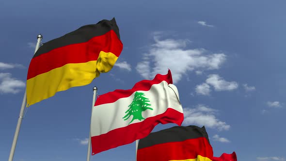 Waving Flags of Lebanon and Germany on Sky Background