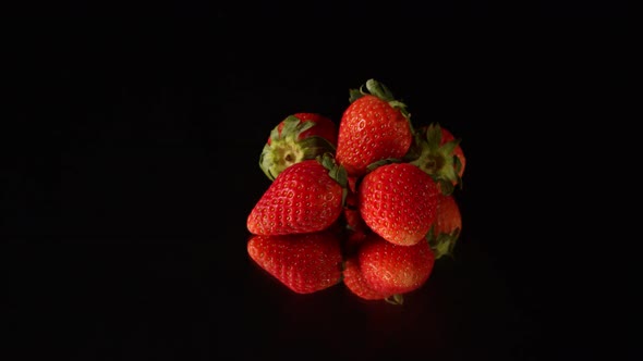 Strawberry Piled Up On The Mirror In Black Background.
