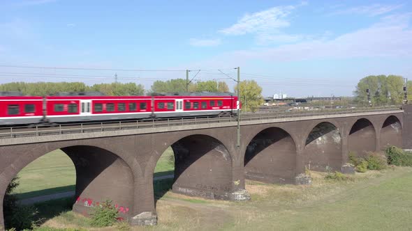 Commuter Train Passing Fast Over an Old Bridge